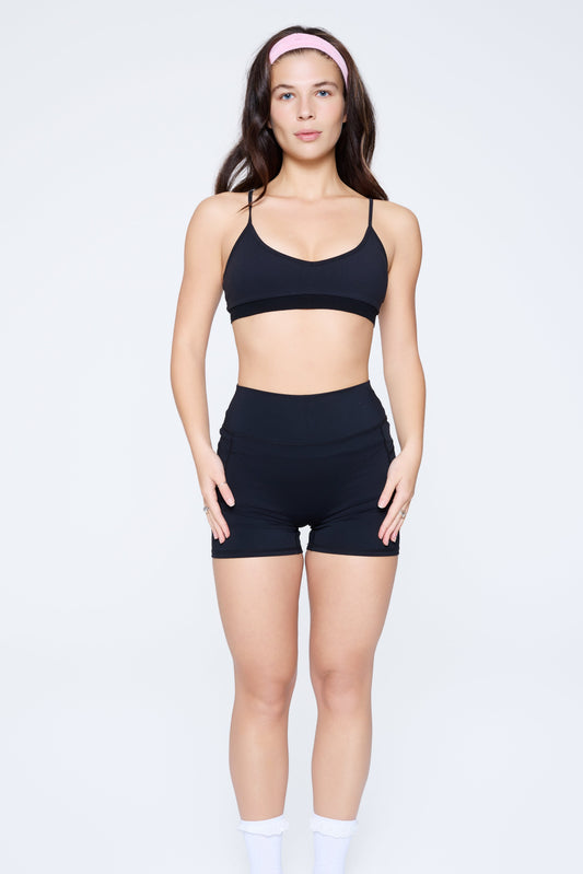 Front shot of model wearing Ruay Muse light form sports bra