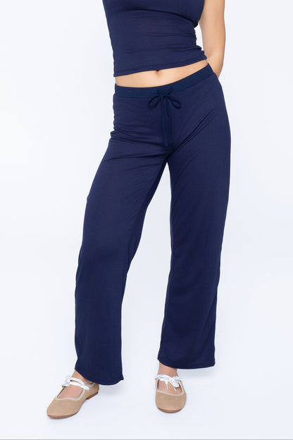 Front shot of model wearing Ruay Muse Column Contrast trousers