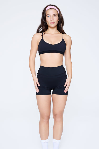 Front shot of model wearing Ruay Muse light form sports bra