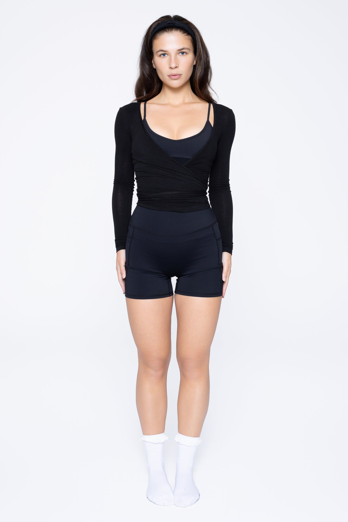 Model wearing Ruay Muse Reformer Wrap Top in Eclipse navy