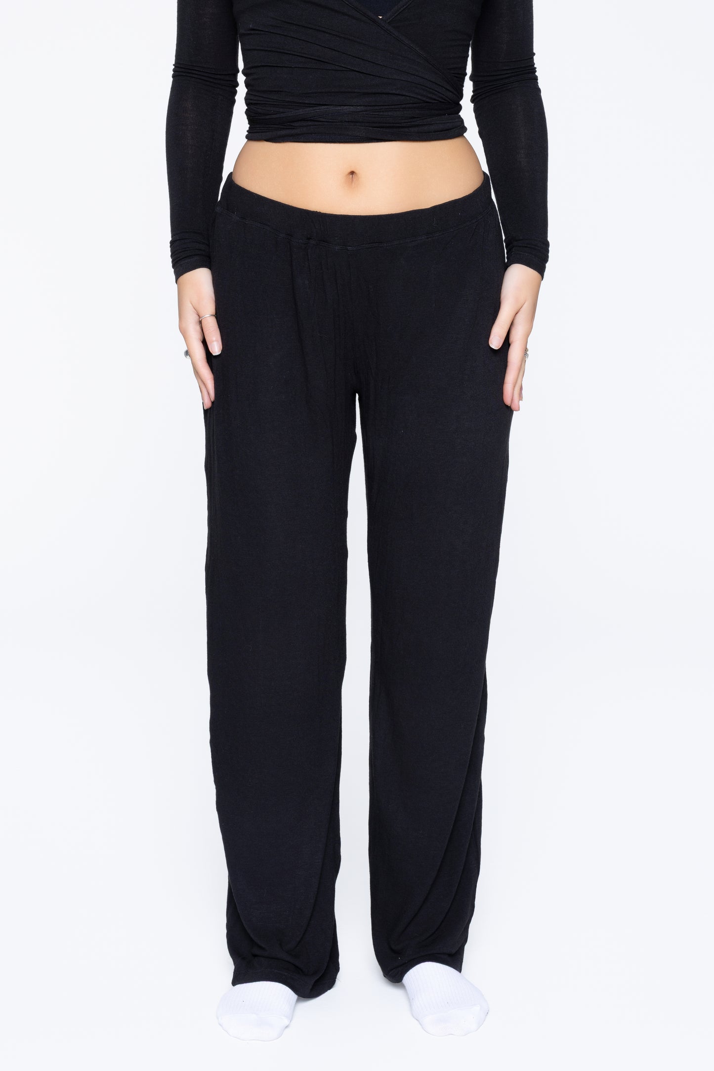 Front shot of model wearing Ruay Muse Reformer trousers in black