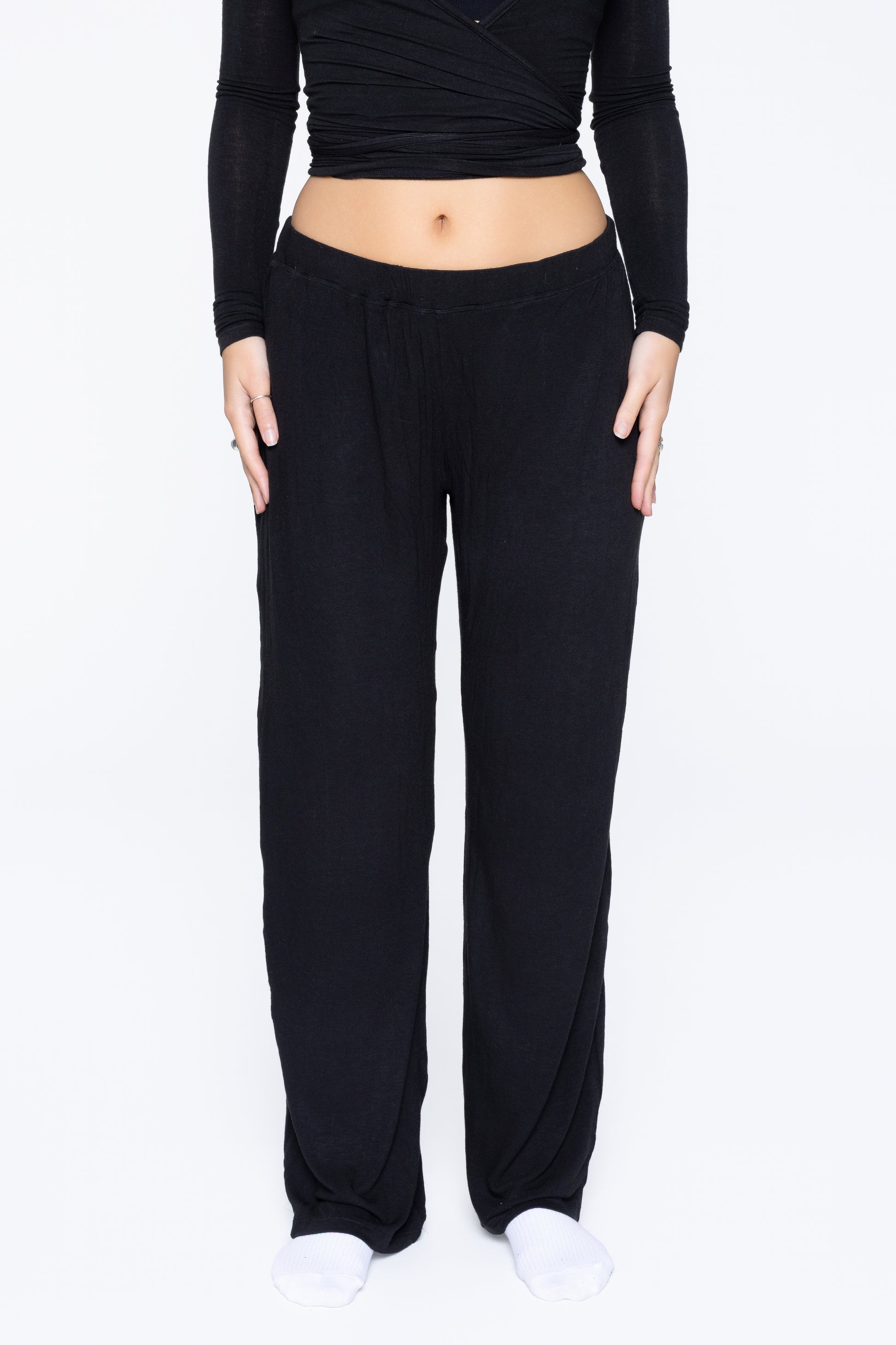 Front shot of model wearing Ruay Muse Reformer trousers in black