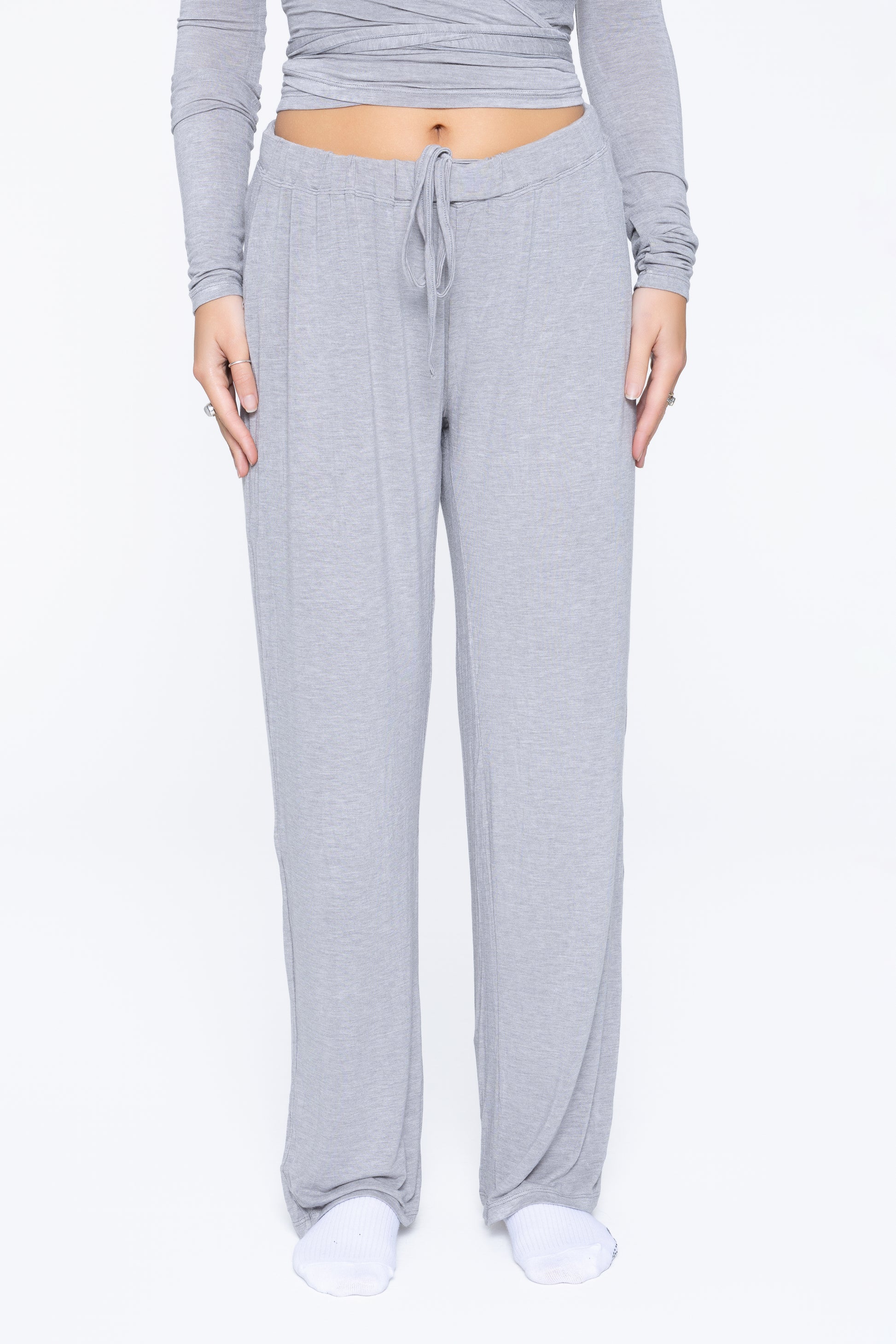 Front shot of model wearing Ruay Muse Reformer trousers in grey