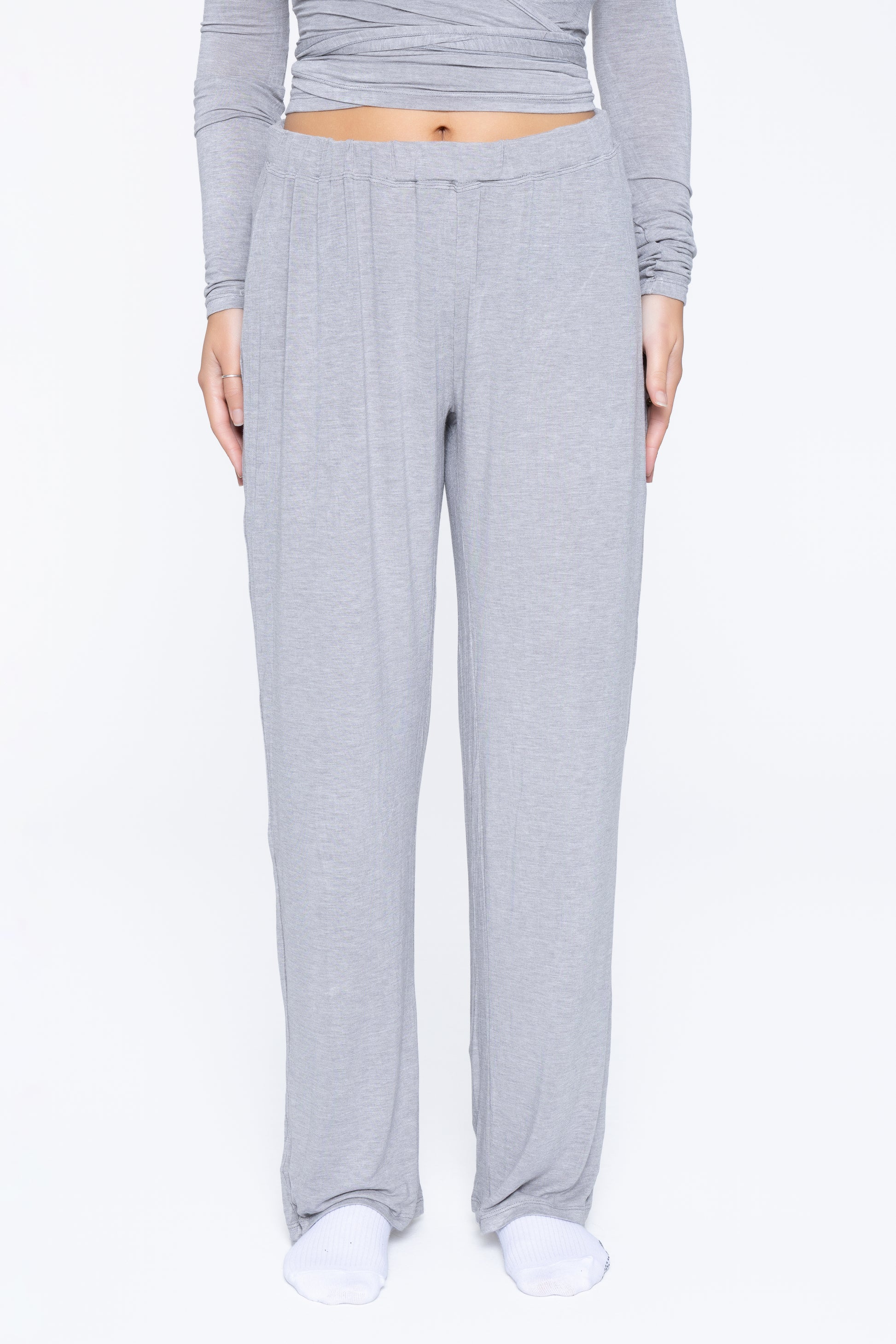 Front shot of model wearing Ruay Muse Reformer trousers in grey