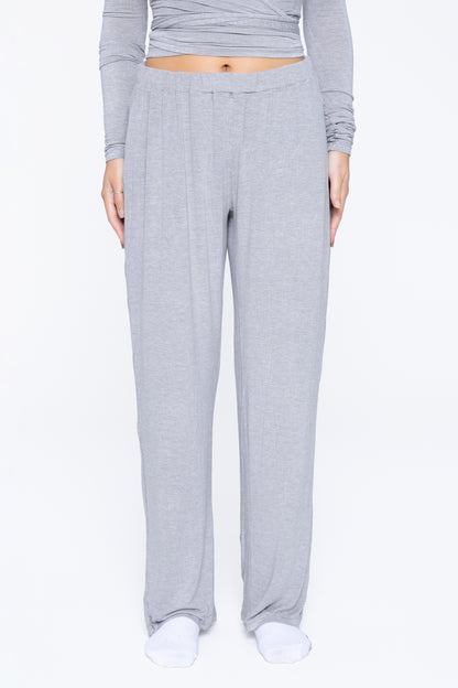 Front shot of model wearing Ruay Muse Reformer trousers in grey