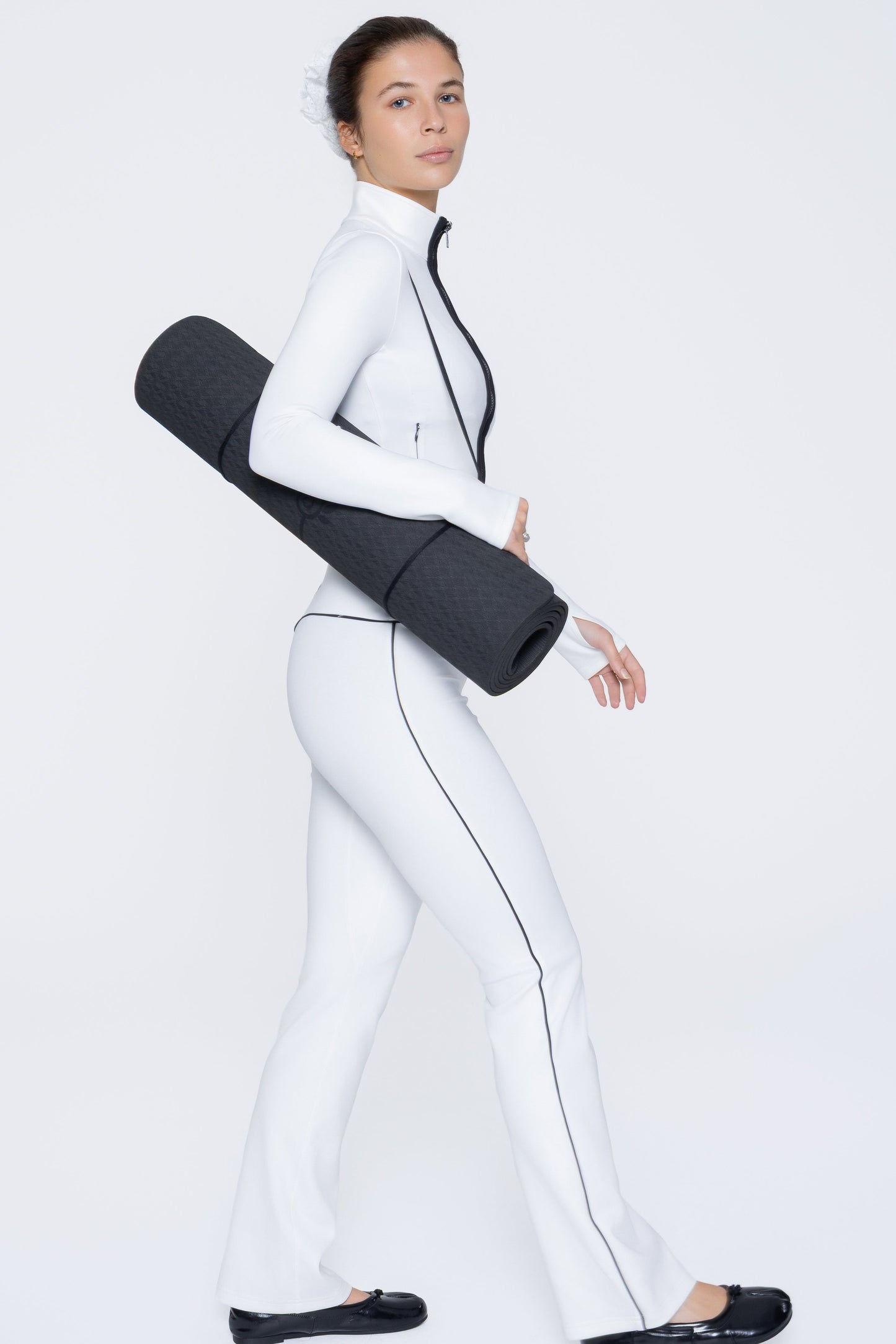 Side shot of model wearing Ruay Muse Axis jacket and trousers