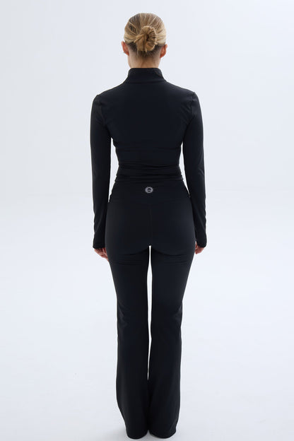 Back shot of model wearing Ruay Muse Silhouet jacket and trousers