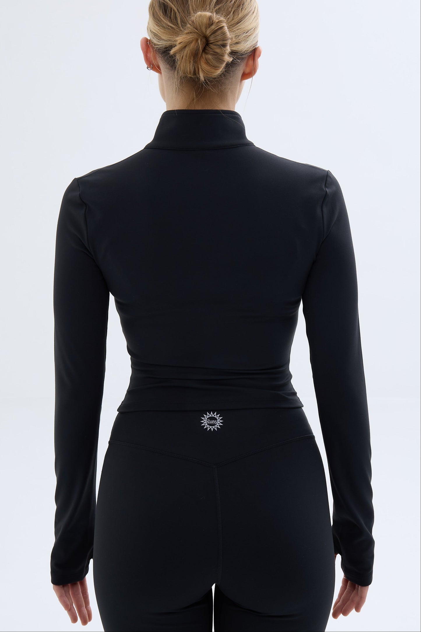 Back shot of model wearing Ruay Muse Silhouet jacket